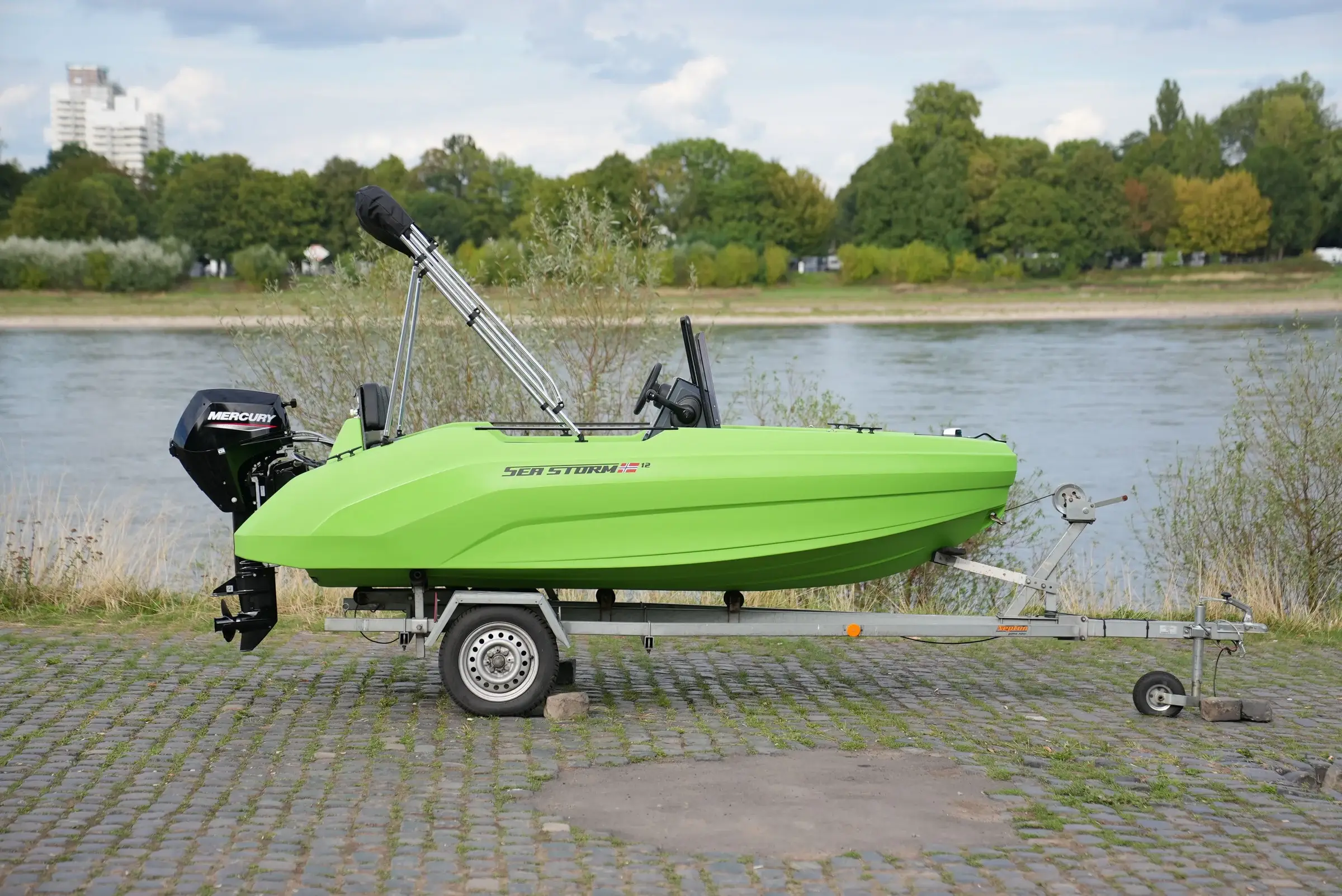 SeaStorm 12 Lime Green on the trailer in side view with Mercury F15