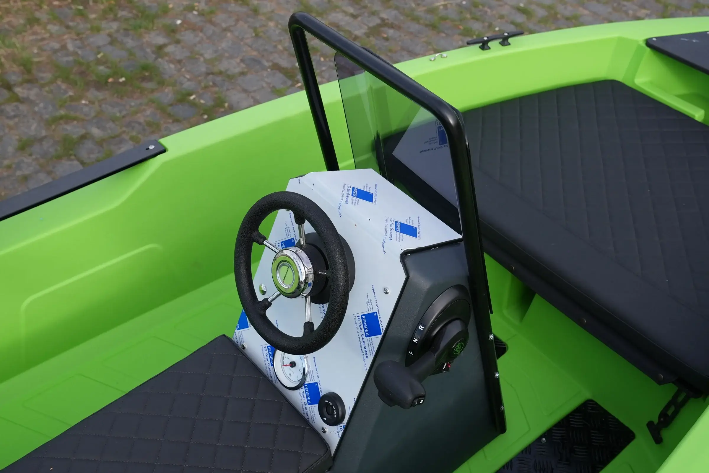 Helm of the SeaStorm 12 with steering wheel and windscreen frame