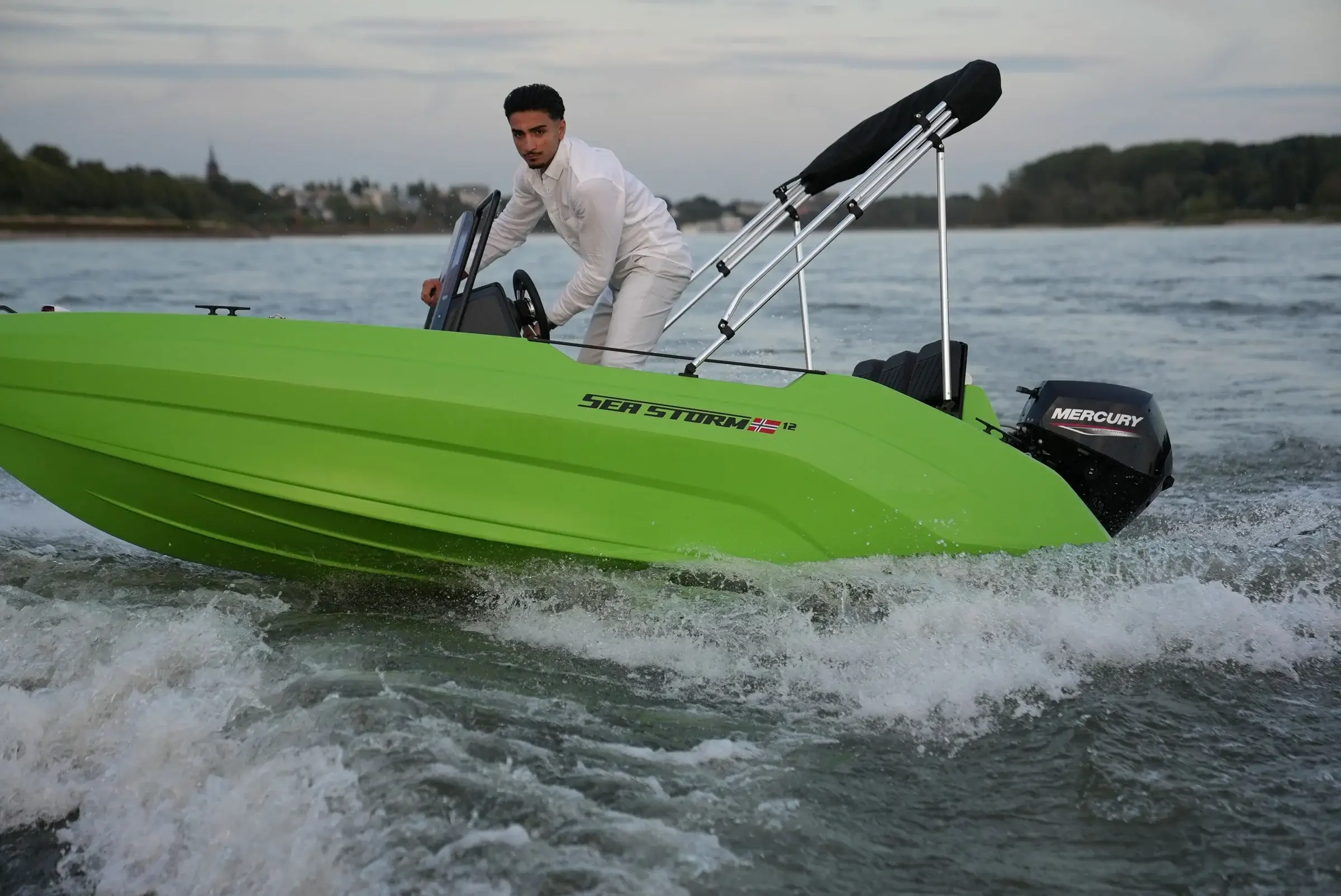 SeaStorm 12 under way, side view with Mercury F15
